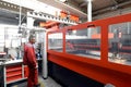 Industrial worker operates a laser cutting machine - employee in