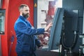 Industrial worker operating cnc machine at metal machining industry Royalty Free Stock Photo