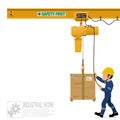 An industrial worker is operating electric chain hoist