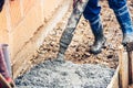 Industrial worker pouring cement or concrete with automatic pump tube Royalty Free Stock Photo