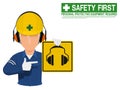 Industrial worker is presenting earmuffs sign