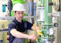 Industrial worker repairs machines and equipment in a refinery