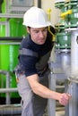 Industrial worker repairs machines and equipment in a refinery