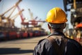 Industrial worker with safety helmet at sea port, back view Royalty Free Stock Photo