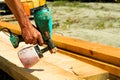 Industrial worker spraying paint over timber wood. Construction worker with spray gun Royalty Free Stock Photo