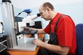 Worker checking probe with industrial microscope Royalty Free Stock Photo