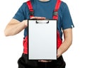 Industrial worker in uniform holding clipboard Royalty Free Stock Photo