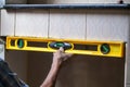 Industrial worker use building level to check balance edge of wall to checking level of wall at construction Royalty Free Stock Photo