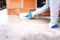 Industrial worker waterproofing part of house exposed to rain Royalty Free Stock Photo