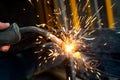 Industrial worker welding metal in steel factory