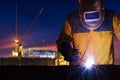 Industrial worker welding steel structure for infrastructure building project with construction site Royalty Free Stock Photo