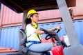 Industrial worker woman wearing safety vest and helmet driving forklift car at factory industry, beautiful African American female Royalty Free Stock Photo