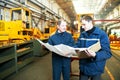 Industrial workers at assembling conveyer line