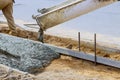 Industrial workers pouring fresh concrete in reinforced cement sidewalk