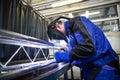 Industrial workers welding metal with many sharp sparks