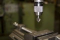 Industrial workshop with classic green drill machine for metal craft work with exchangeable countersink drill bit