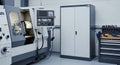Industrial Workshop Interior Featuring CNC Machine Metalworking Equipment Storage Cabinet and Tools Against a White Wall Royalty Free Stock Photo