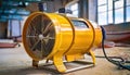 Industrial yellow fan in a workshop setting for ventilation Royalty Free Stock Photo