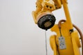 industrial yellow robot working head. technology arm in factory. automation business manufacturing