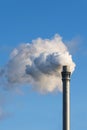 Industry chimney with clouds of smoke against the blue sky, copy Royalty Free Stock Photo