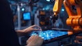 Industry 4.0 concept .Man hand holding tablet with Augmented reality screen software and blue tone of automate wireless