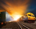 industry container trainst running on railways track against beautiful sun set sky use for land transport and logistic business Royalty Free Stock Photo