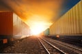 industry container trainst running on railways track against beautiful sun set sky use for land transport and logistic business Royalty Free Stock Photo