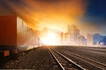 industry container trainst running on railways track against beautiful sun set sky use for land transport and logistic business Royalty Free Stock Photo