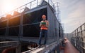 Industry engineer under checking the industry cooling tower air conditioner is water cooling tower air chiller HVAC of large indus Royalty Free Stock Photo