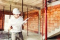 Industry engineer working on site, man reading paper plans and supervising works Royalty Free Stock Photo