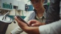 Industry engineers check equipment maintenance. Male hands hold tablet closeup.