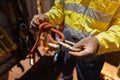 Industry inspector worker hand inspecting, tie, secure a low stretch red rope with barrel knot into screwgate Royalty Free Stock Photo