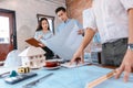 Industry manager and engineer, businessman reading and checking blueprint, drawing in the room