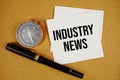 Industry News text on sticky note with compass and pen on paper craft background Royalty Free Stock Photo