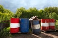 Industry oil barrels or chemical drums stacked up.Stack Of Oil barrels on the background of green trees Royalty Free Stock Photo