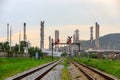 Industry oil and gas refinery factory zone with railways foreground and mountain with sky background