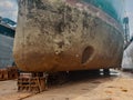 Industry view - Ocean Vessel in the dry dock in shipyard. Old rusty ship under repair Royalty Free Stock Photo