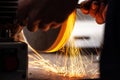 Industry worker grinds a metal instrument