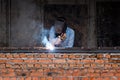 Industry worker welding iron pieces on new building Royalty Free Stock Photo
