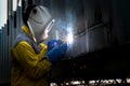 Industry worker with welding steel to repair container structure