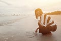 Indy asian women smile draw heart shape on sand beach