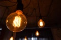 Big vintage incandescent light bulbs hanging in modern kitchen. Decorative antique edison light bulbs with straight wire. Dimmable