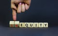 Inequity or equity symbol. Businessman turns wooden cubes and changes the word inequity to equity. Business and inequity or equity