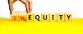 Inequity or equity symbol. Businessman turns wooden cubes and changes the word inequity to equity. Business and inequity or equity