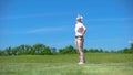 Inexperienced woman golfer dissatisfied about failed shot, looking up, loser Royalty Free Stock Photo