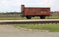 Infamous rail car, barbed wire fence and barracks in the background, of Auschwitz concentration camp Royalty Free Stock Photo