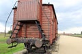 Infamous rail car, gate house with guard tower in the background, of Auschwitz concentration camp