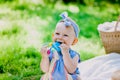 Infancy and age concept . beautiful happy baby in pink dress in the park playing Royalty Free Stock Photo