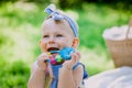 Infancy and age concept . beautiful happy baby in pink dress in the park playing Royalty Free Stock Photo