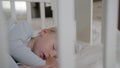 Infancy, beloved sleeping baby sleeps soundly and sees good dreams in crib